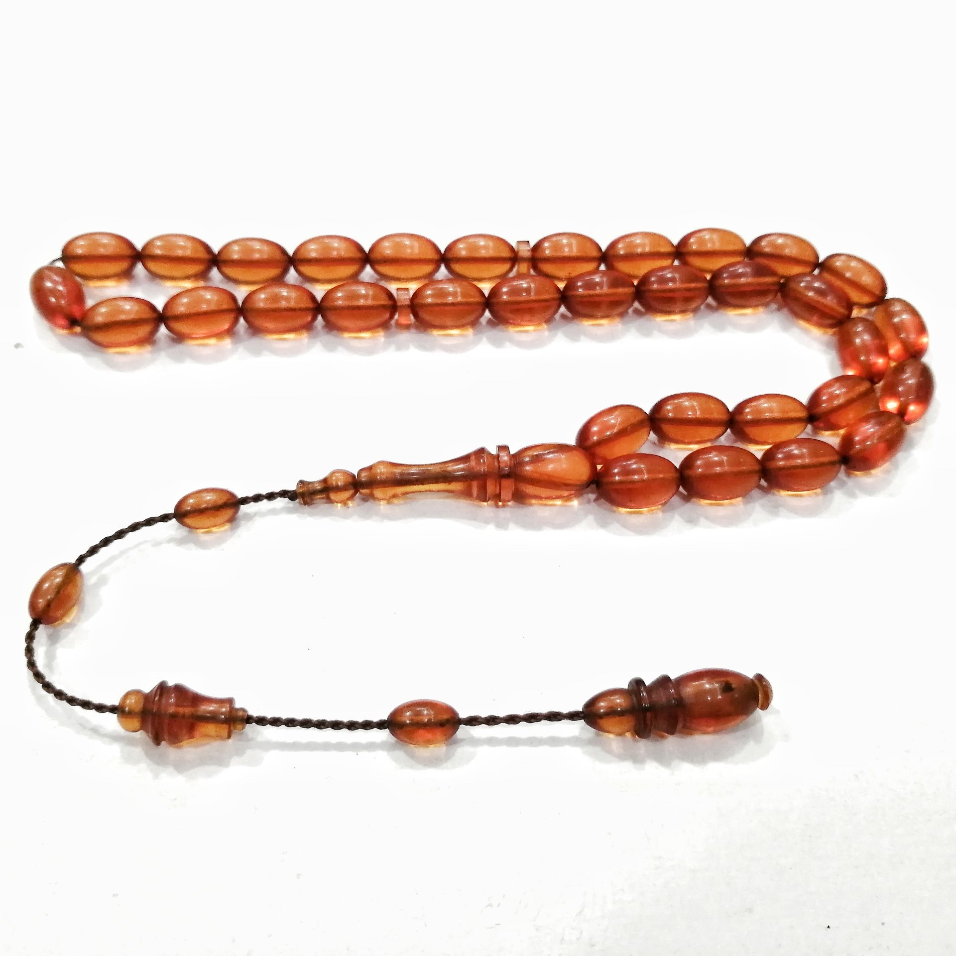 Sistem Püsküllü Sikke İmzalı Badem Kesim Ateş Kehribar Tesbih